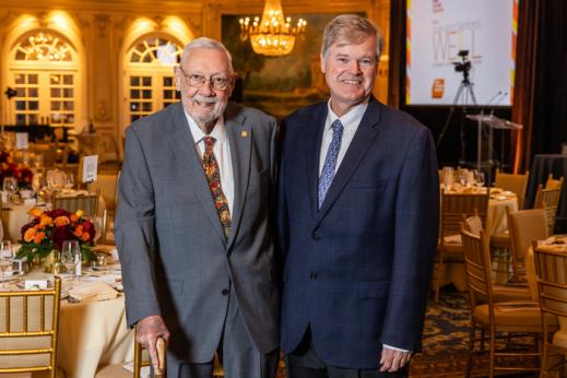 Two men posing for a photo at a gala